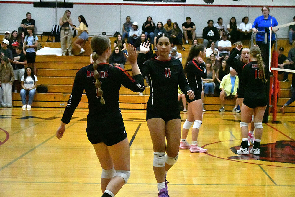 Lola Marti (7) high fives Joella Posini (11) in a match earlier this year